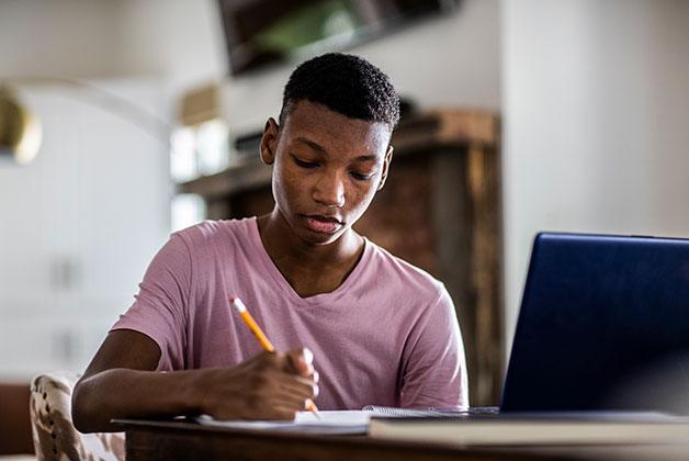 a young girl writing on a book